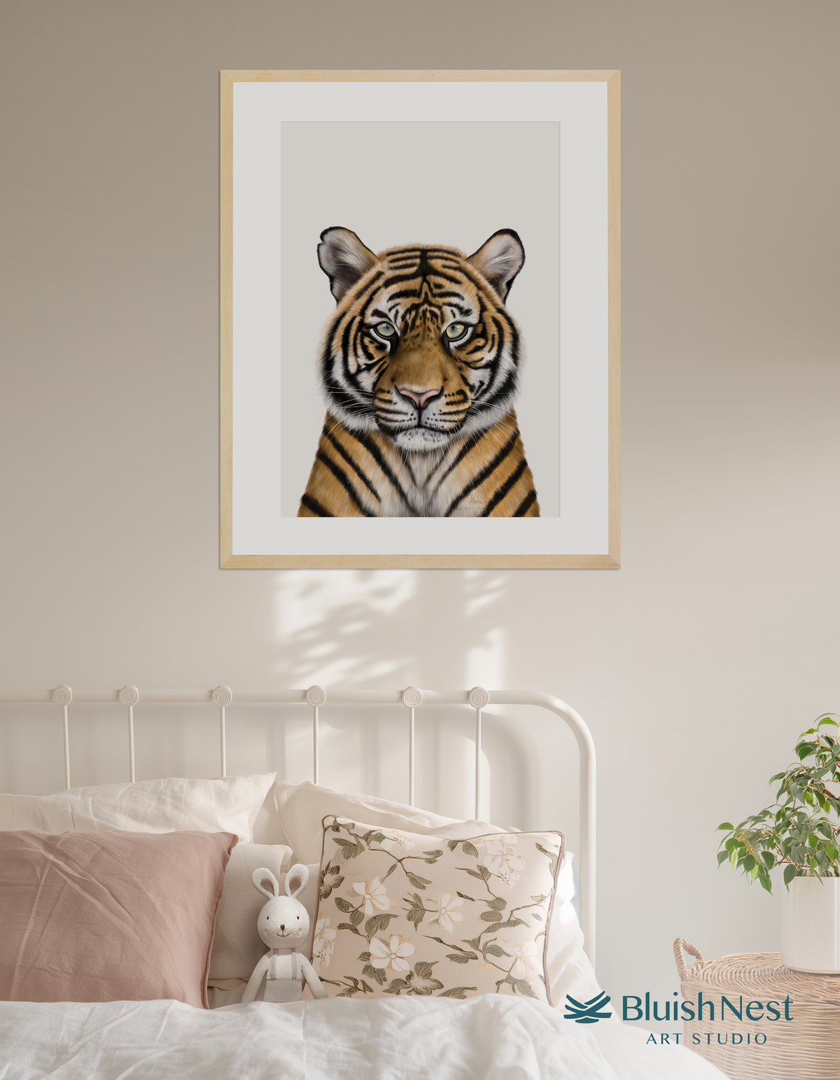 A framed nursery and children's wall art print of a tiger on a wall above a bed - Blush Nest Art Studio