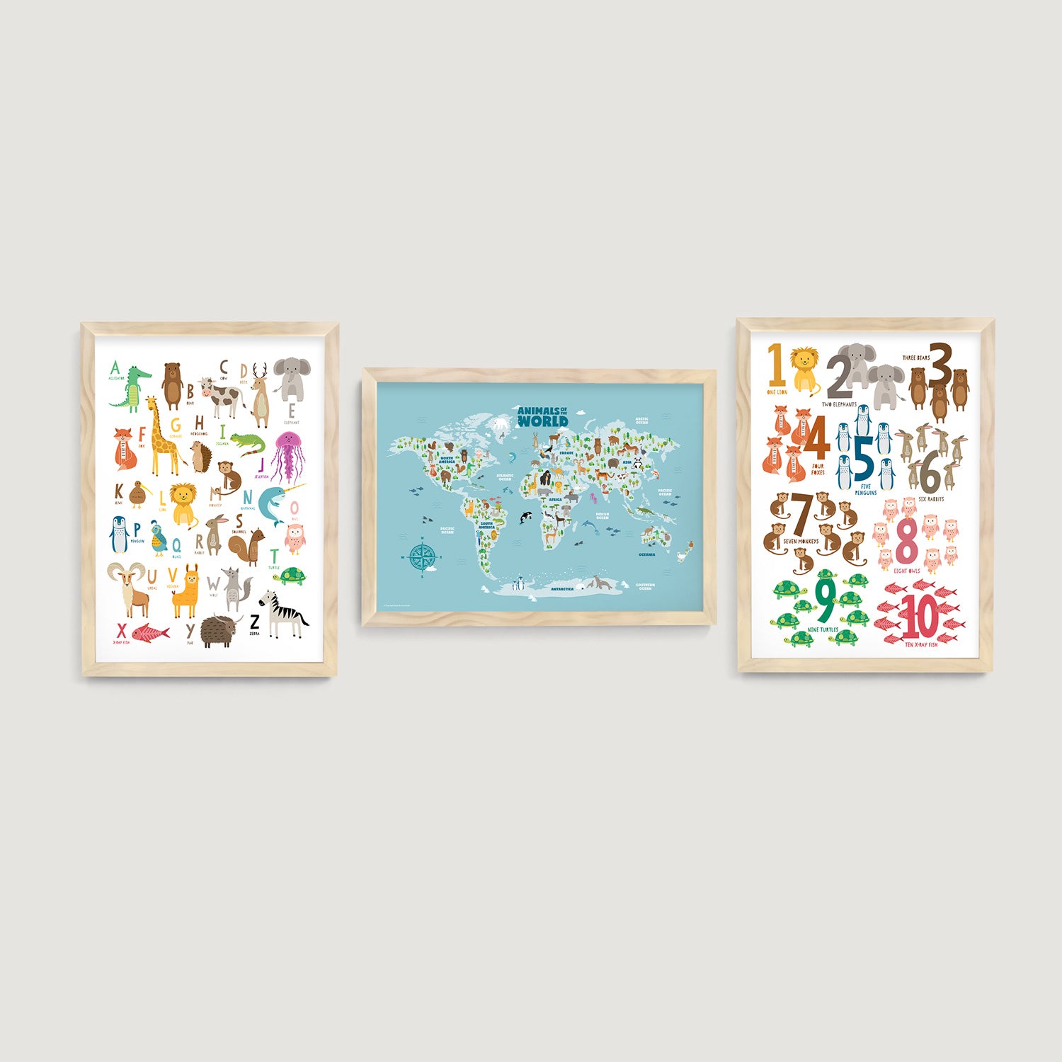 Three framed educational nursery and kids wall art prints on a wall, including a world map, numbers and alphabet charts - Bluish Nest Art Studio