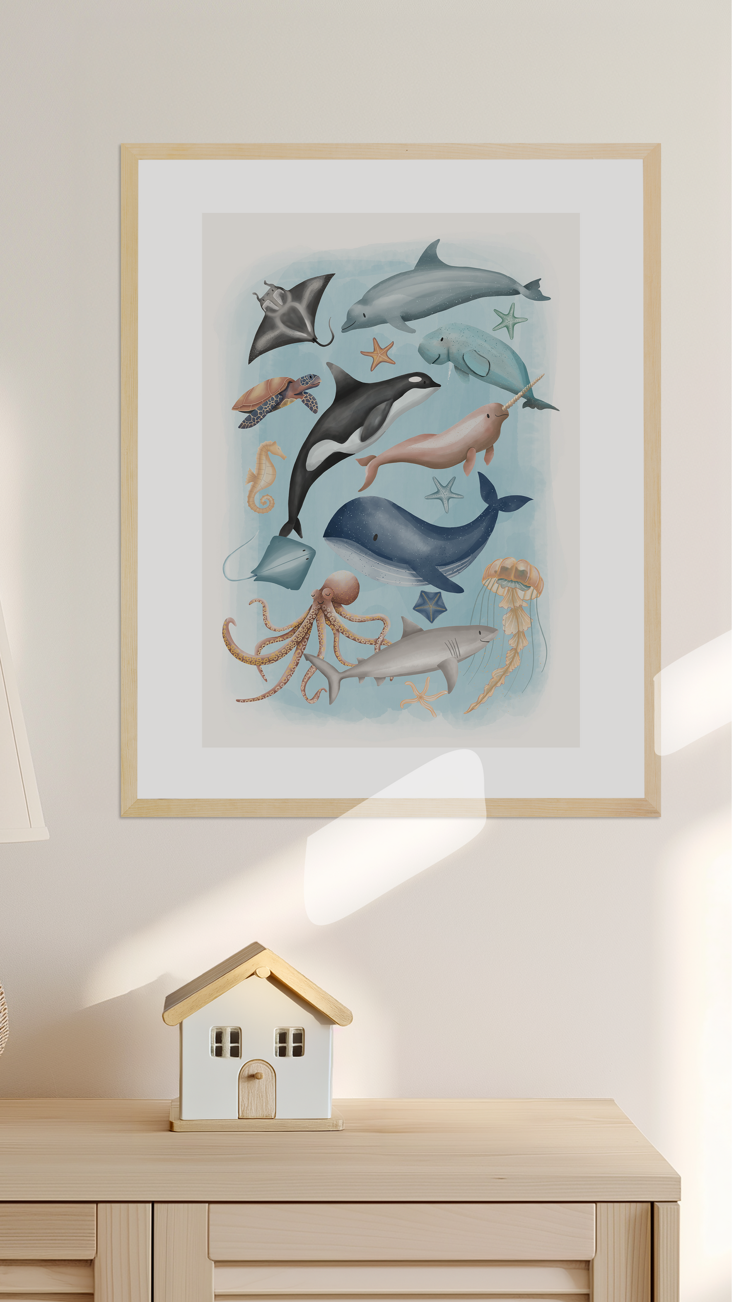 Framed kids and baby wall art print of sea creatures on a wall above a wooden cabinet with a small house decoration - room decor  - Bluish Nest Art Studio