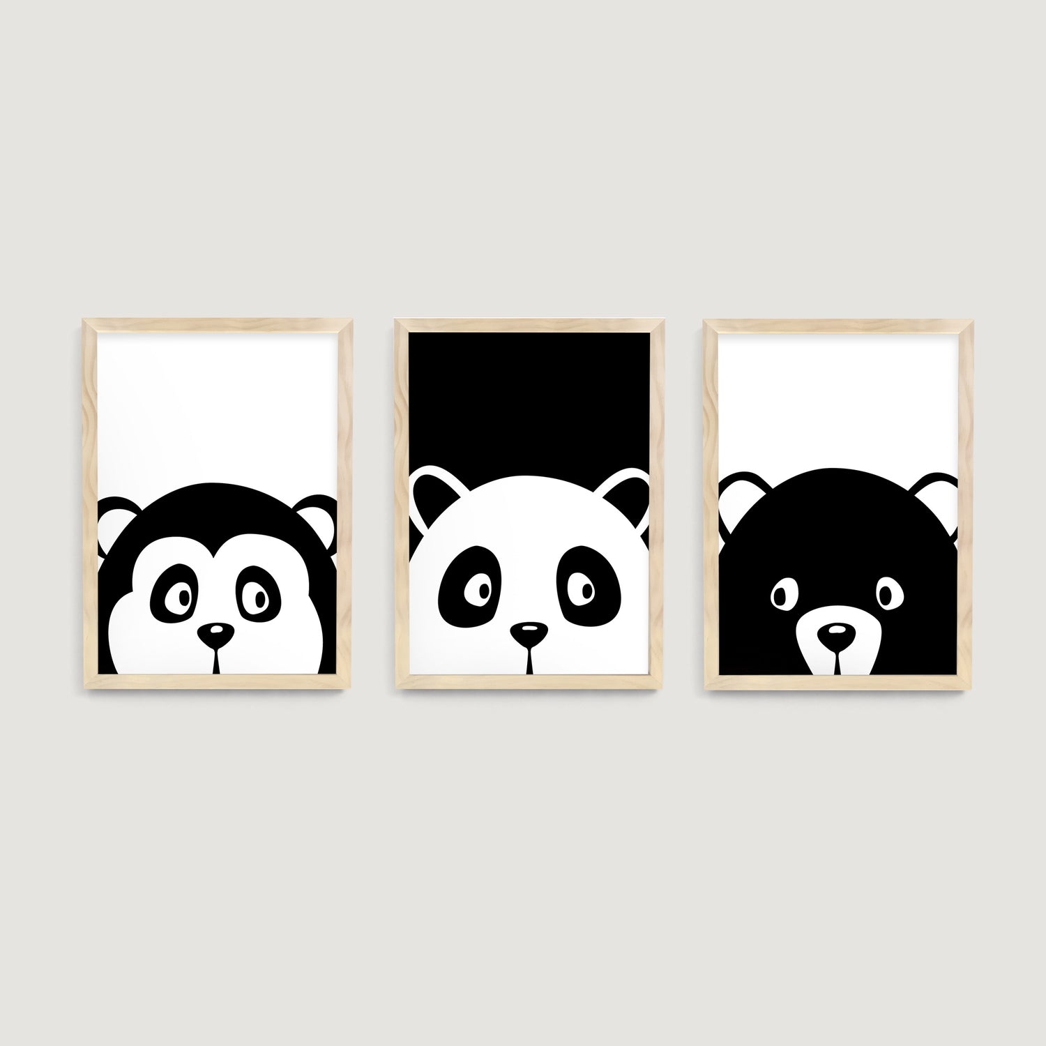 Three framed nursery and kids wall art prints of black and white monkey, bear and panda animals on a white wall - Bluish Nest Art Studio