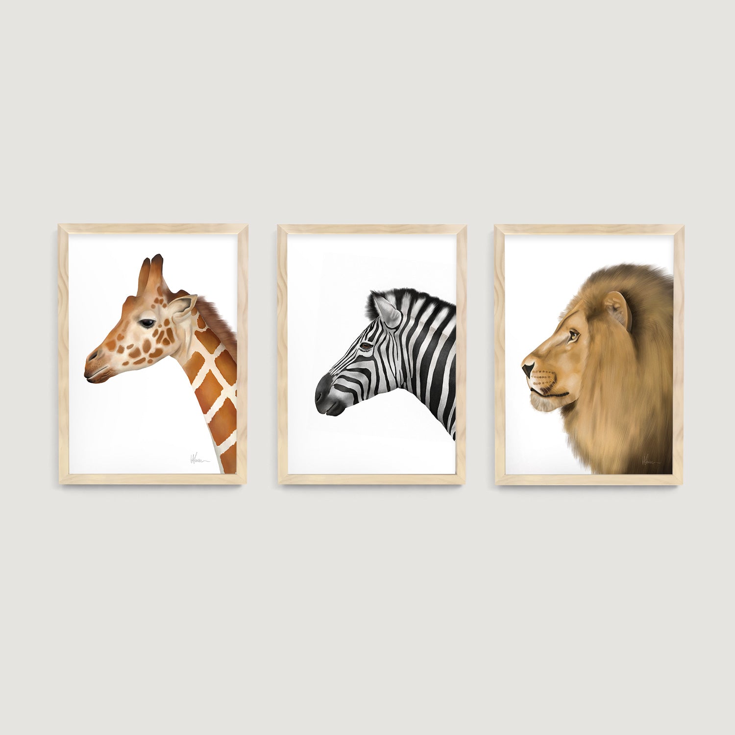 Three framed nursery and kids wall art prints of a safari giraffe, zebra, and lion on a light gray background  - Bluish Nest Art Studio