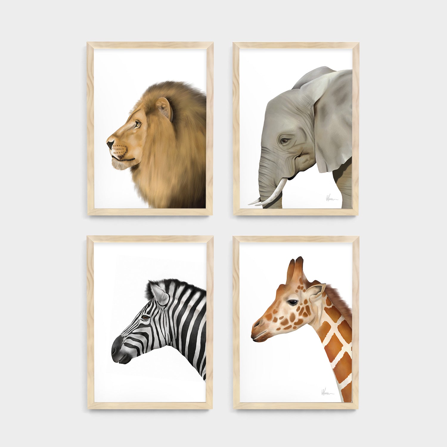 Four framed kids and baby wall art prints of a safari lion, elephant, zebra, and giraffe on a white background  - Bluish Nest Art Studio