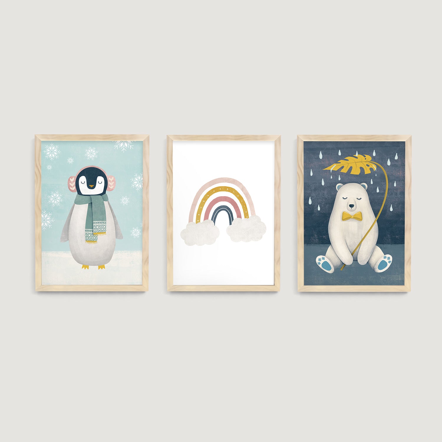 Three framed baby and children wall art prints of a penguin, rainbow, and polar bear on a light gray background  - Bluish Nest Art Studio