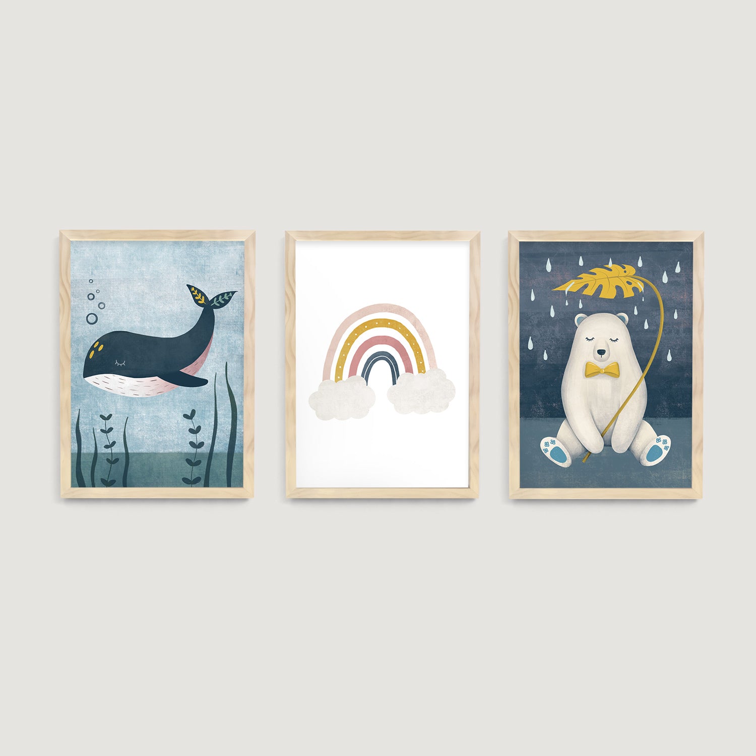 Three framed baby and kids wall art prints of a whale, rainbow, and polar bear on a wall  - Bluish Nest Art Studio
