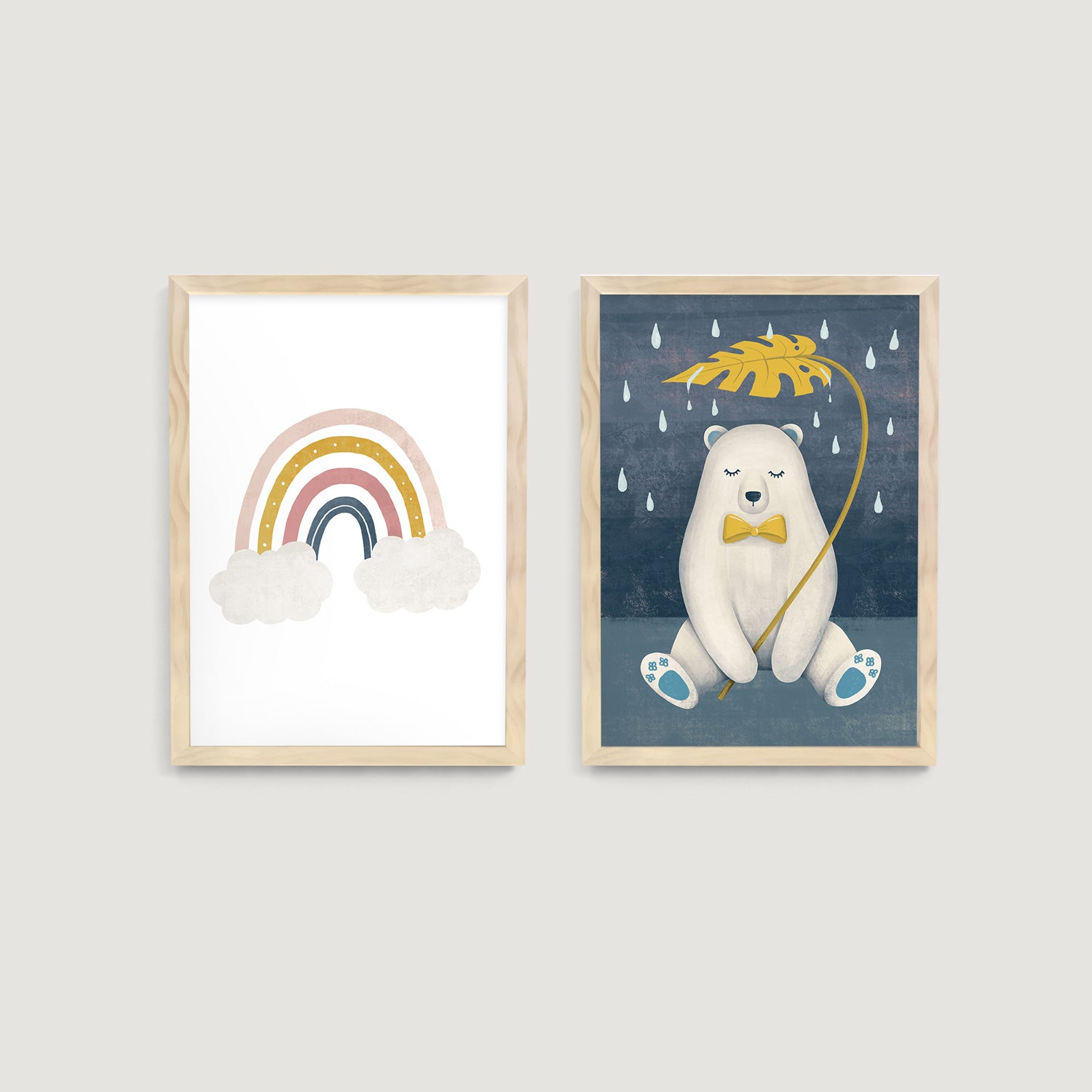 Two framed illustrations on a wall, one with a rainbow and clouds, the other with a bear holding an umbrella  - Bluish Nest Art Studio