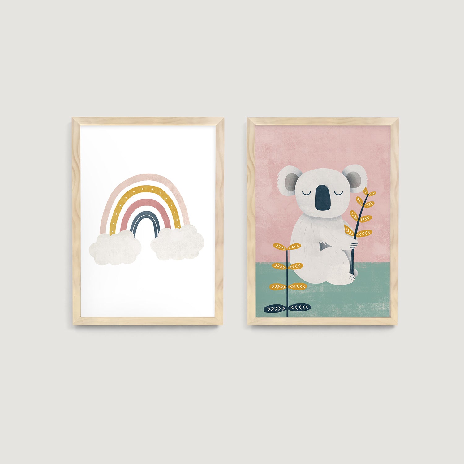 Two framed children and baby wall art prints on a wall, one with a rainbow and clouds, the other with a koala bear  - Bluish Nest Art Studio