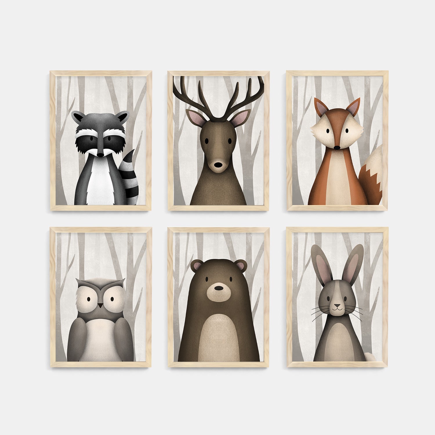 Set of six framed kids and nursery wall art prints of forest animals usch as racoon, stag, fox, owl, bear and rabbit on a white background - Bluish Nest Art Studio