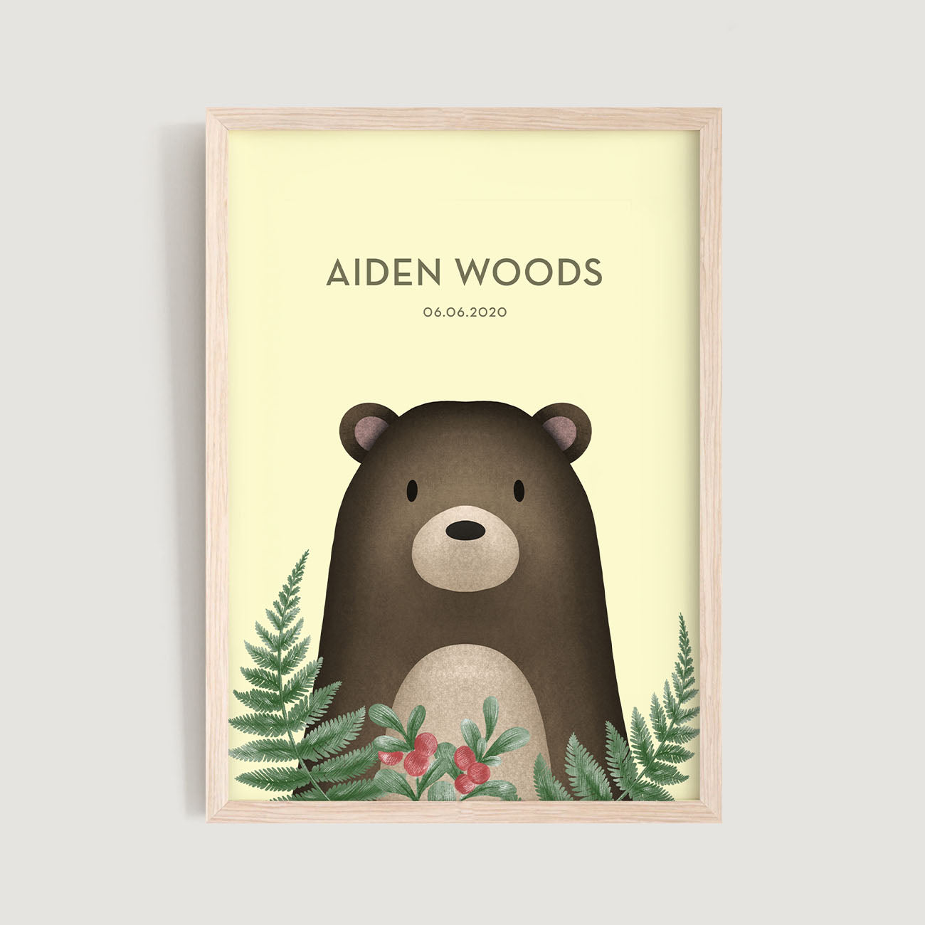 A framed personalised birth baby and kids wall art print of a woodland bear with floral leaves and text in yellow background - Bluish Nest Art Studio