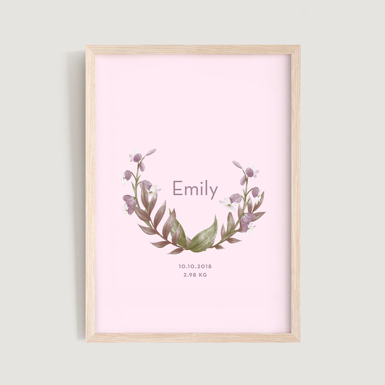 A framed personalised birth baby and kids wall art print of a floral wreath and text in pink background - Bluish Nest Art Studio