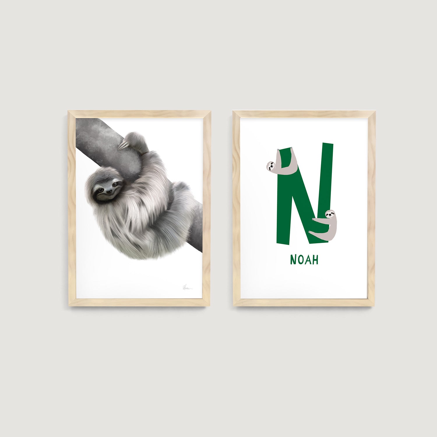 Two nursery framed art prints with a sloth animal and a personalised print letter 'N' on a light gray background - Bluish Nest Art Studio