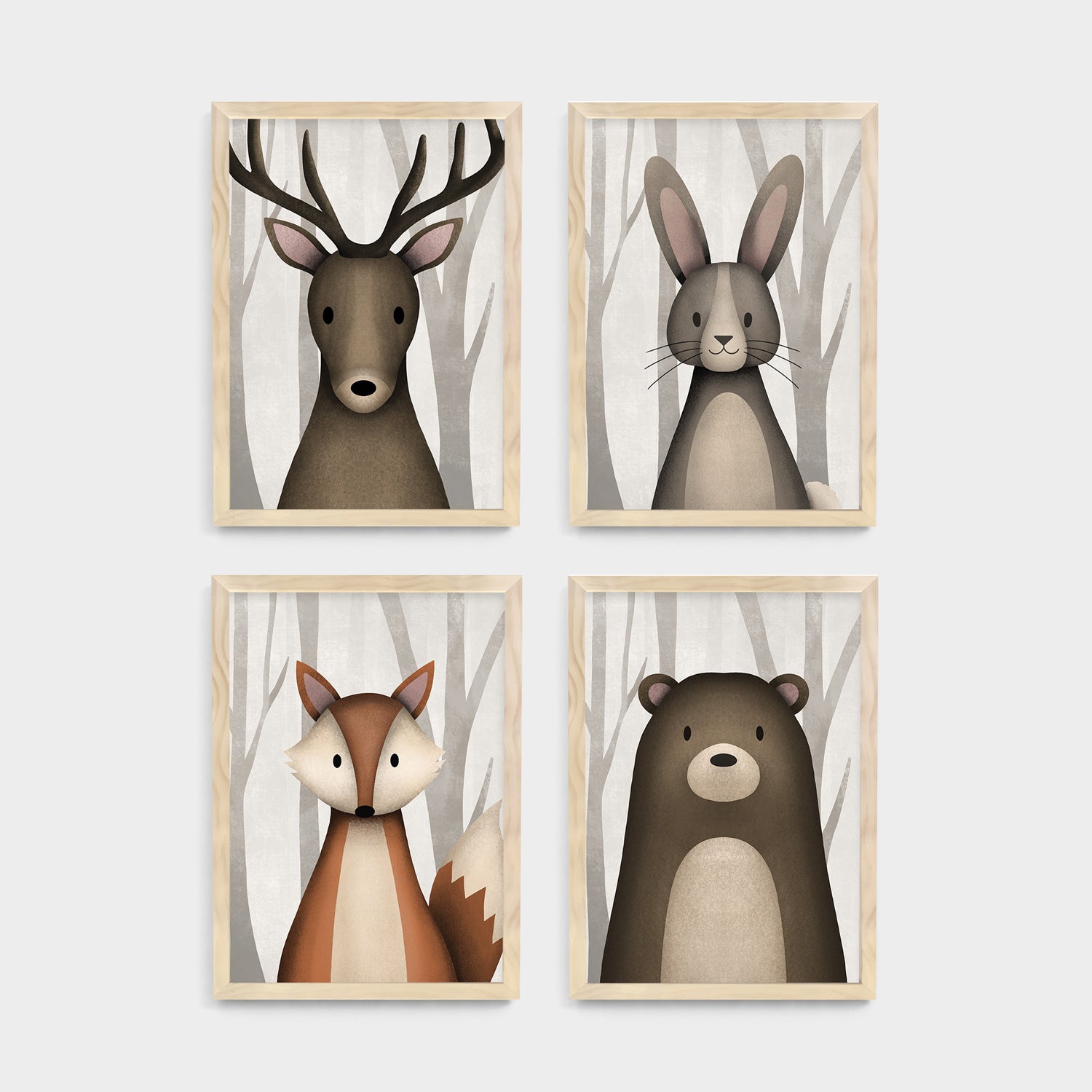 Four framed kids and nursery wall art prints of a deer, rabbit, fox, and bear on a white background - Bluish Nest Art Studio