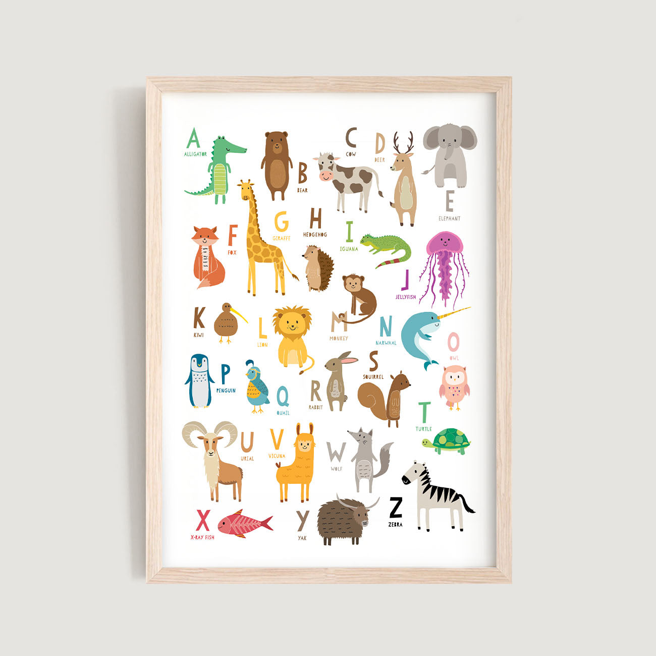 A nursery and kids wall art print with the letters of the alphabet and illustrations of animals corresponding to each letter, presented in a light wood frame - Bluish Nest Art Studio