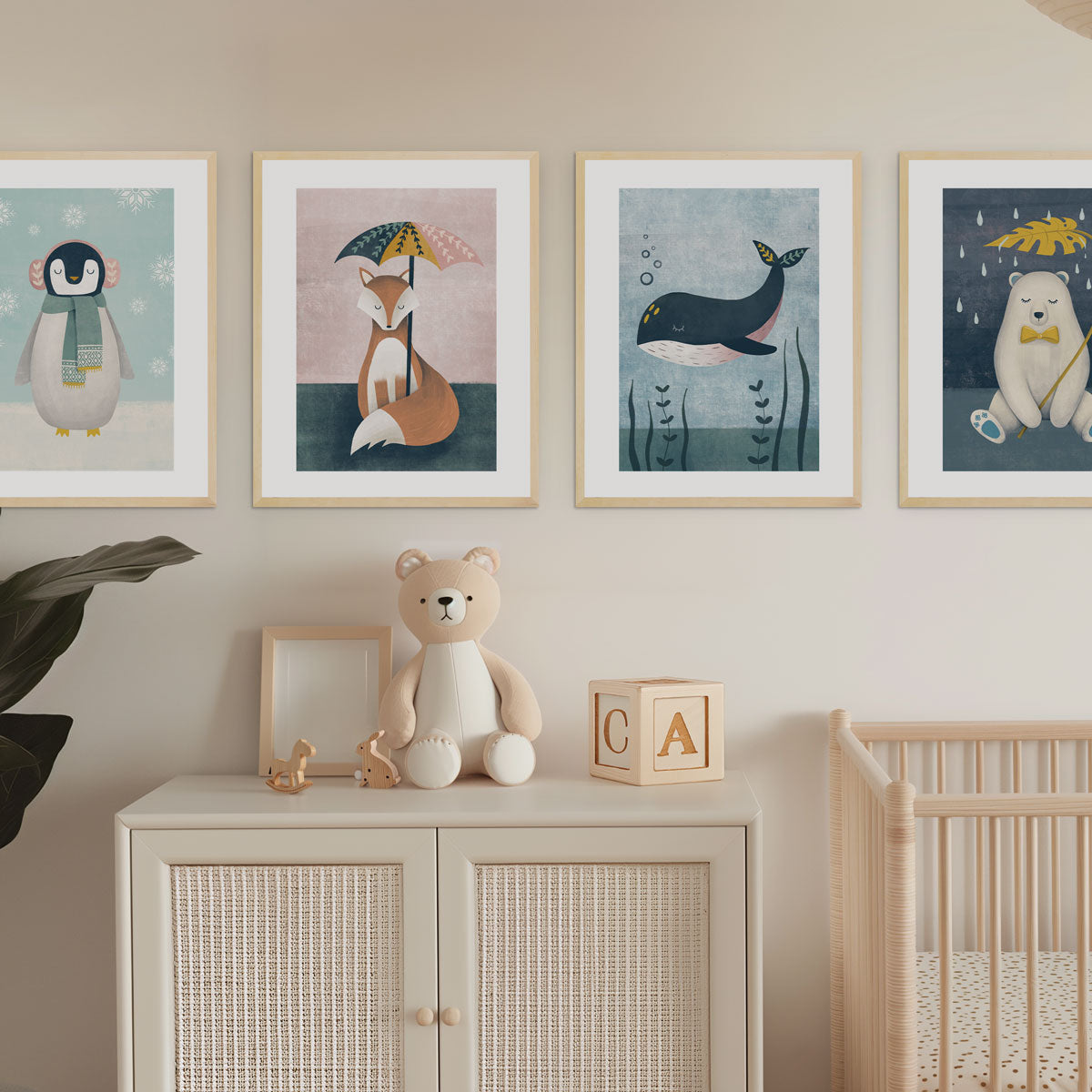 Modern nursery room decor with framed baby and kids art prints on the wall, a cabinet with toys, and a crib - Bluish Nest Art Studio